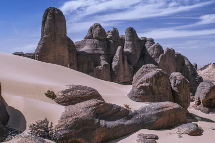 HD desktop wallpaper showcasing the sand dunes and rocky formations of Tadrart in Tassili N'Ajjer National Park, Sahara Desert, Algeria, Africa.
