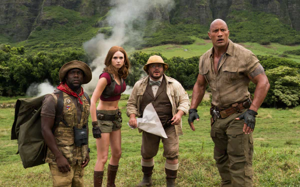 HD wallpaper featuring Kevin Hart, Karen Gillan, Jack Black, and Dwayne Johnson in a scene from the movie Jumanji: Welcome to the Jungle, set in a lush and adventurous landscape.