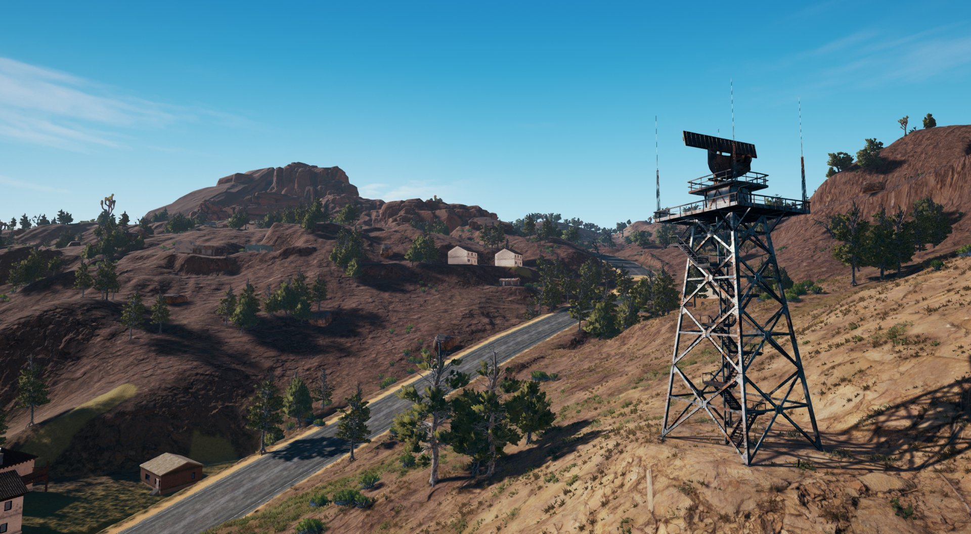 HD desktop wallpaper featuring a landscape from the video game PlayerUnknown's Battlegrounds. The scene depicts a deserted mountainous area with a radar tower and a road winding through the terrain.