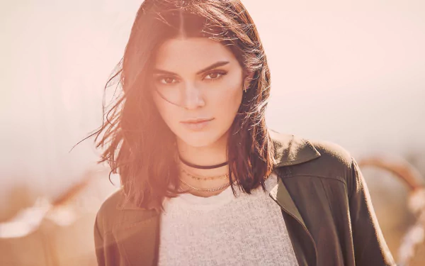 A striking portrait of a brunette model with a confident expression, featuring a soft depth of field that adds an artistic touch. This HD image showcases Kendall Jenner's unique style.