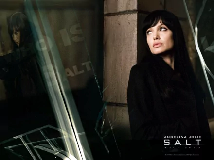 HD PC desktop wallpaper featuring Angelina Jolie from the movie Salt, with a moody and intense atmosphere.