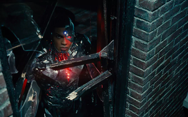 Cyborg (DC Comics) from Justice League (2017) movie — cybernetic hero with glowing red eye and chest, metal limbs bracing against a brick wall; HD PC desktop wallpaper/background.