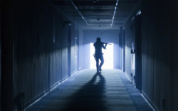 Silhouette of Rick Grimes, played by Andrew Lincoln, walking down a dim hallway, holding a rifle, from the TV show The Walking Dead in 4K Ultra HD quality.