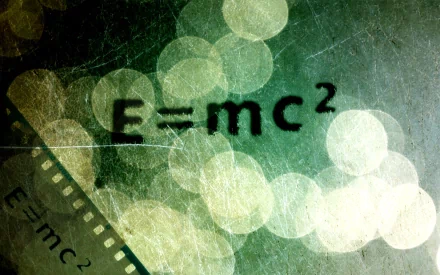 HD desktop wallpaper featuring the equation E=mc² against a background with bokeh lights and a filmstrip element, tagged with mathematics and math.