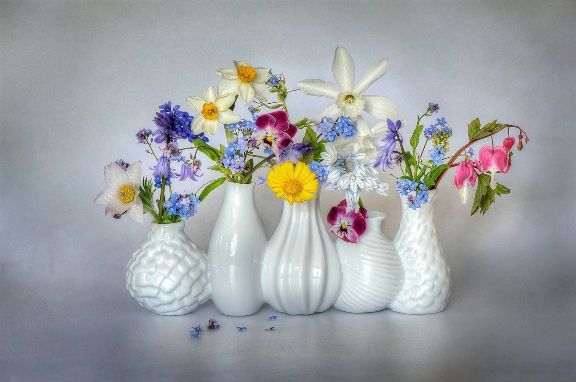 A colorful arrangement of various flowers in white, man-made vases against a soft background, designed as an HD PC desktop wallpaper and background.
