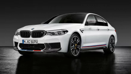 White BMW M5 sedan showcased on a dark background, highlighting its sleek design and sporty accents, captured in high-definition for a PC desktop wallpaper.