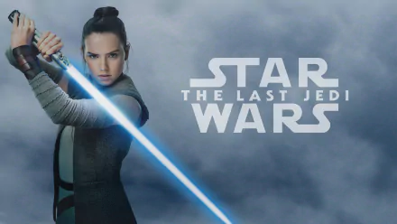 HD desktop wallpaper featuring Daisy Ridley as Rey from the movie Star Wars: The Last Jedi, wielding a lightsaber with the Star Wars logo and movie title in the background.