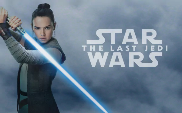 HD desktop wallpaper featuring Daisy Ridley as Rey from the movie Star Wars: The Last Jedi, wielding a lightsaber with the Star Wars logo and movie title in the background.