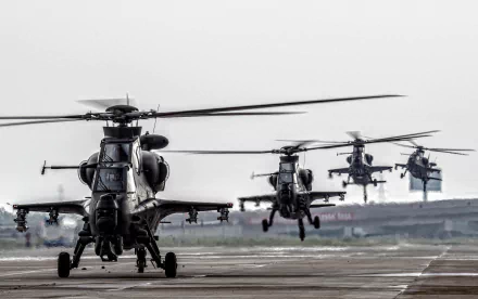 HD desktop wallpaper featuring multiple CAIC Z-10 military attack helicopters in formation on a runway, showcasing advanced aircraft design and aerial power.
