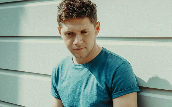 HD desktop wallpaper and background featuring a contemplative man against a wall, tagged with a celebrity's name.