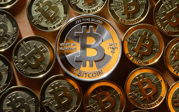 HD desktop wallpaper featuring a collection of golden bitcoins as a representation of cryptocurrency.