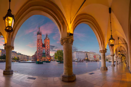 View of Kraków’s historic cathedral and city square framed by arched architecture and warm lantern light, captured in stunning 4K Ultra HD detail.