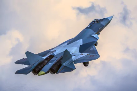 HD wallpaper of a Sukhoi Su-57 military jet fighter soaring through a cloudy sky, showcasing its sleek design as a modern warplane aircraft.