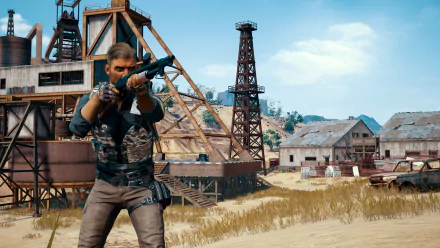 HD PC desktop wallpaper featuring a PlayerUnknown's Battlegrounds character aiming a rifle in an industrial, rugged outdoor setting.