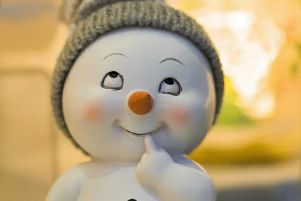 Artistic ceramic snowman figurine with knit hat and rosy cheeks, thoughtful smile, 5K Ultra HD PC desktop wallpaper/background.