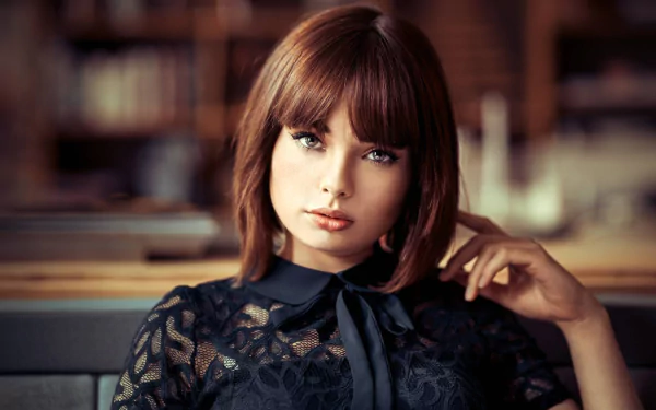 HD desktop wallpaper featuring a close-up portrait of brunette model Marie Grippon with short hair, captured with a shallow depth of field.