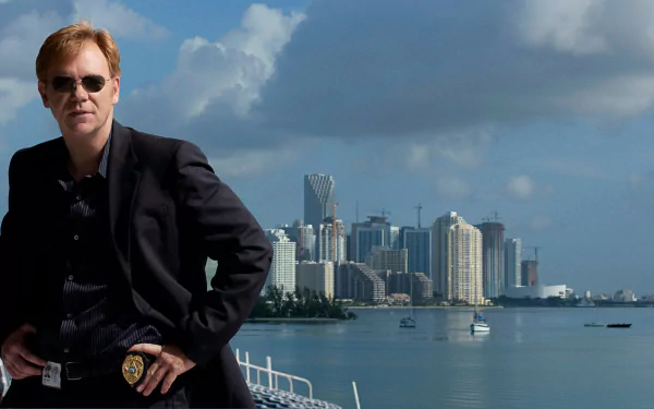 HD desktop wallpaper featuring a character from the TV show CSI: Miami standing confidently with the Miami skyline and waterfront in the background.