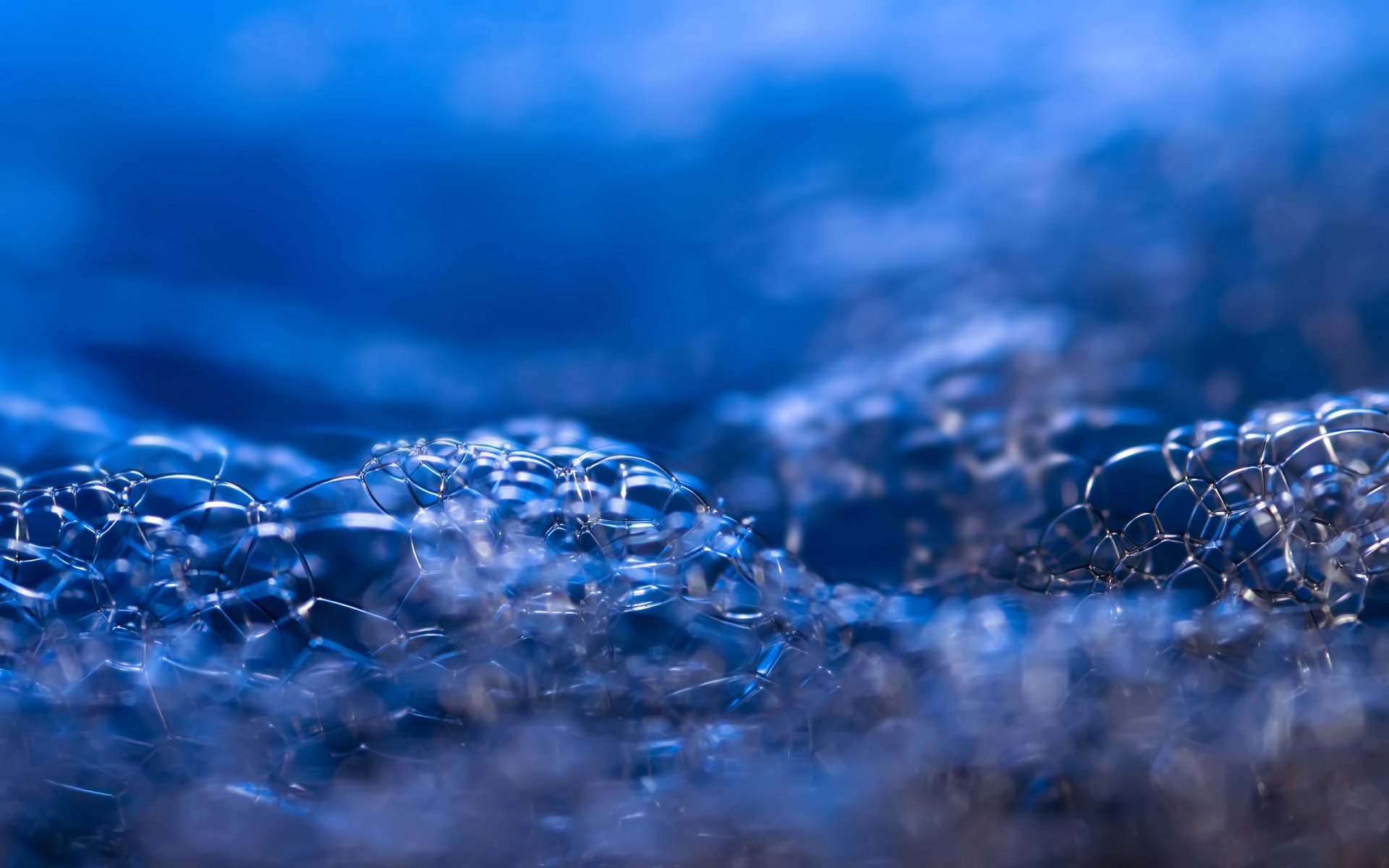 Close-up of shimmering water bubbles in blue tones, captured in high definition as a nature-themed PC desktop wallpaper and background.