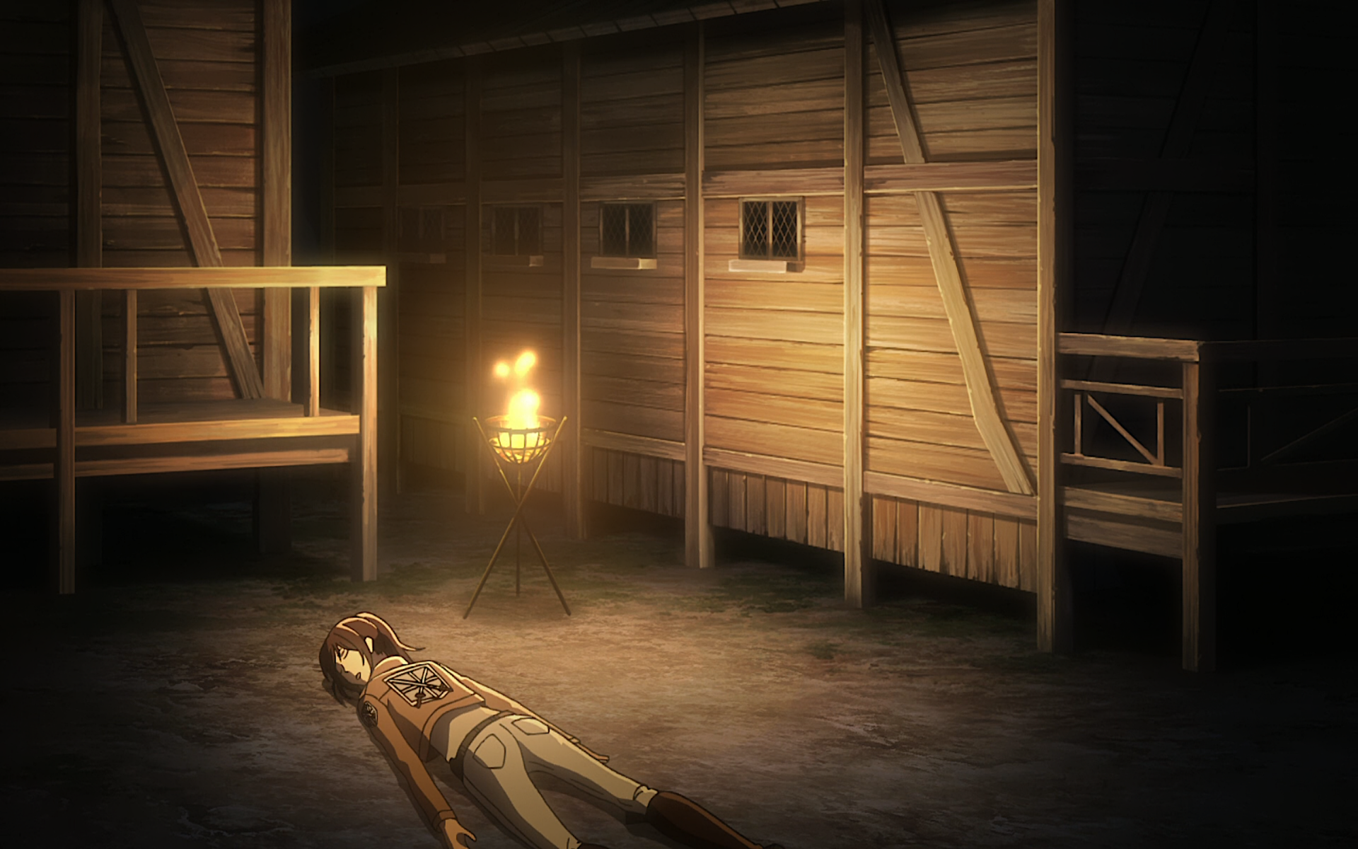 HD desktop wallpaper featuring Sasha Blouse from Attack on Titan resting on the ground beside wooden structures and a burning torch illuminating the scene.