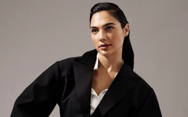 4K Ultra HD portrait of Israeli actress and model with brunette hair and brown eyes, wearing a black blazer and lipstick against a neutral background.