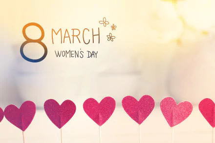 4K Ultra HD Women's Day wallpaper featuring a soft background with a row of red hearts and 8 March Women's Day text decorated with small flowers.