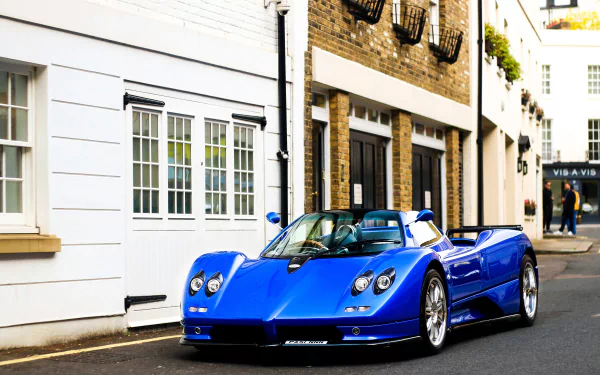 A vivid blue Pagani Zonda supercar parked on a street, showcased as a high-definition PC desktop wallpaper background.