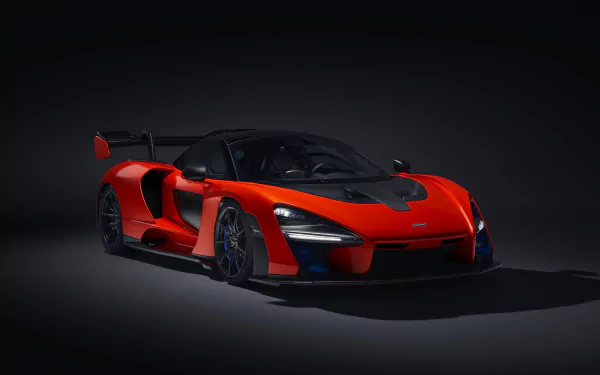 HD wallpaper of a stunning red McLaren Senna supercar showcased against a dark background.