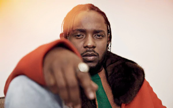 HD desktop wallpaper and background featuring Kendrick Lamar in a red jacket and fur collar, looking thoughtfully at the camera.