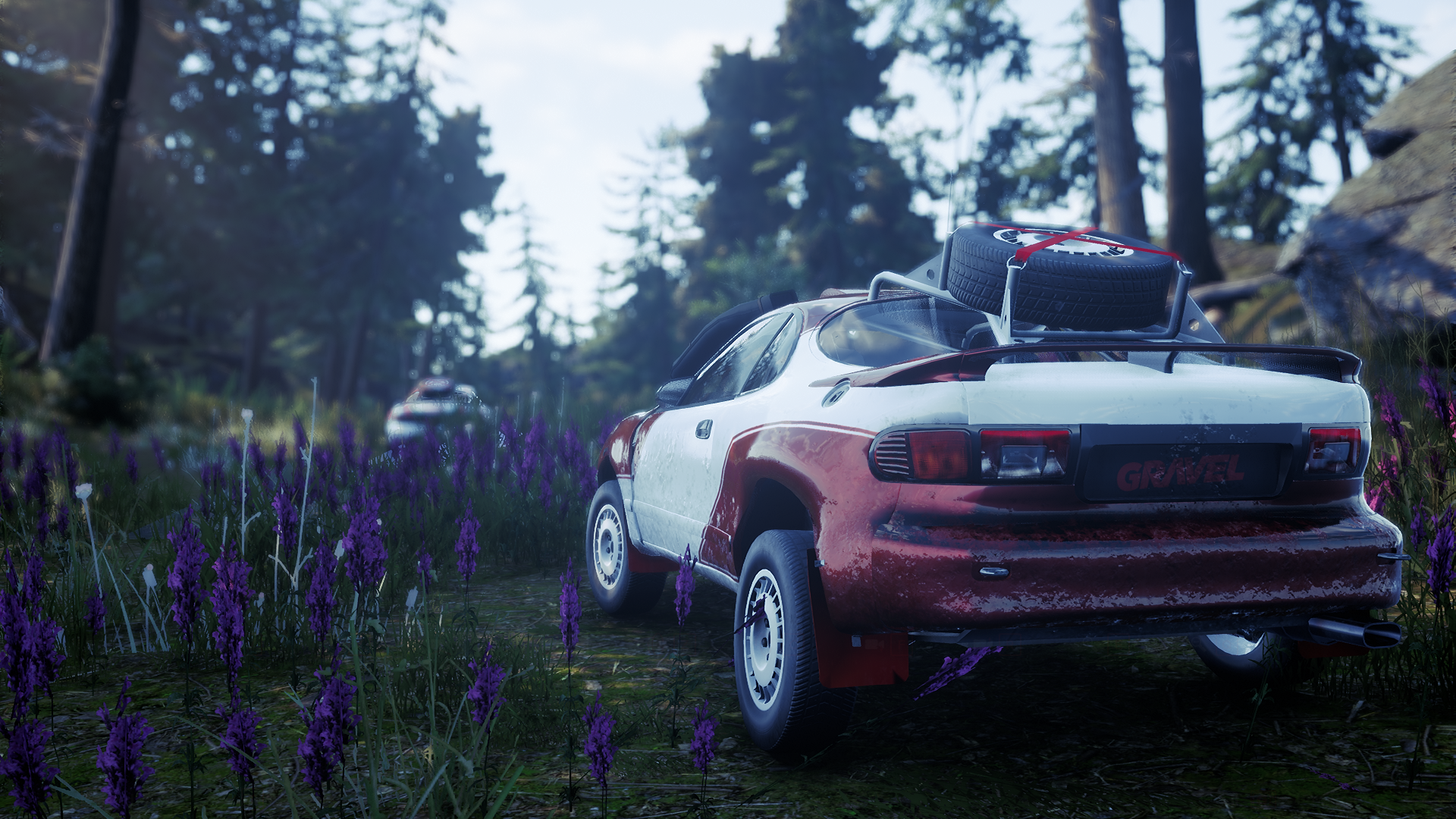 HD desktop wallpaper featuring a rally car on a gravel road amidst a forest and purple wildflowers.