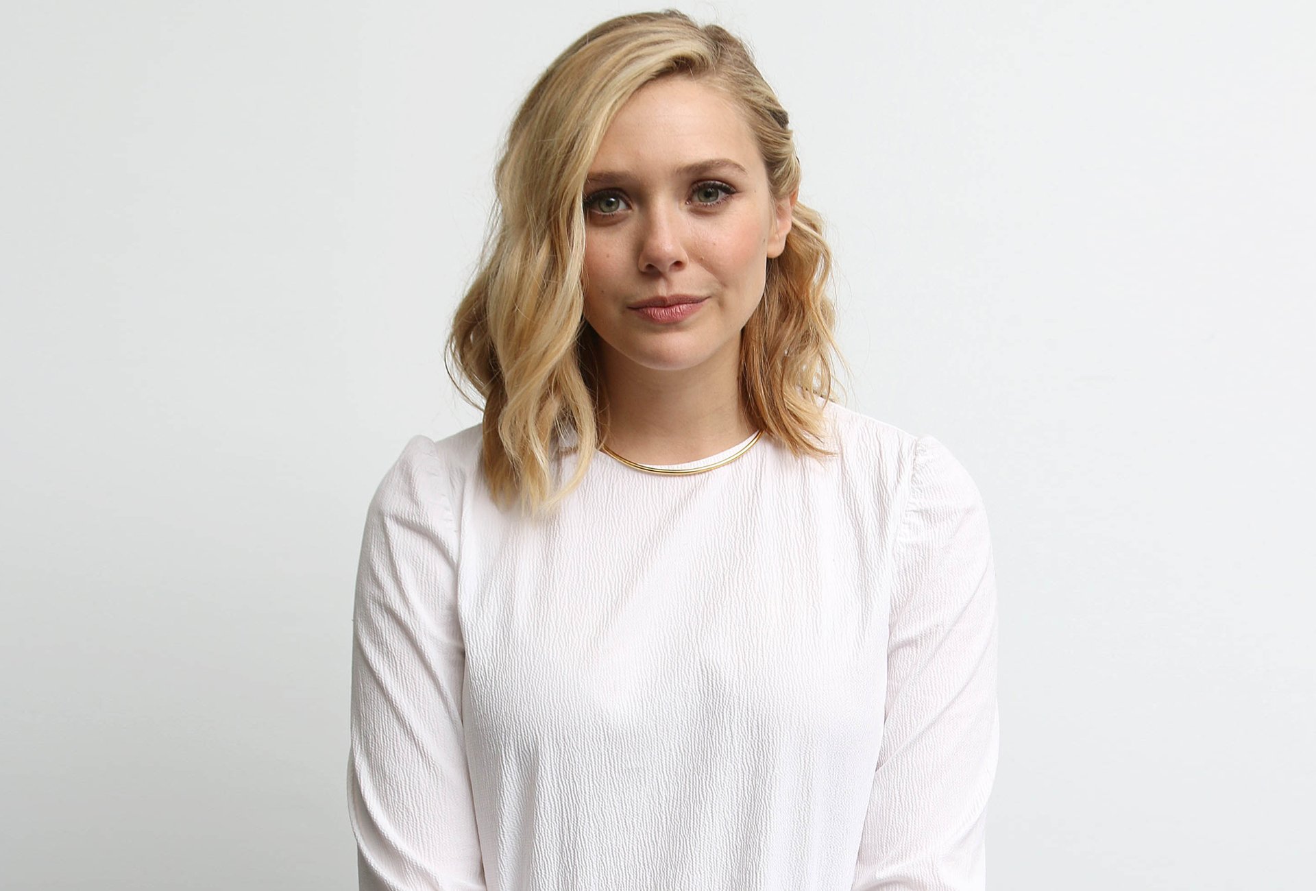HD PC desktop wallpaper featuring a clear, high-quality portrait of celebrity Elizabeth Olsen in a white top against a plain background.