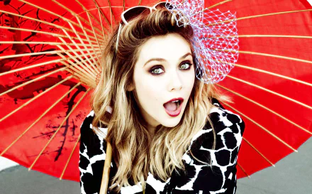 HD PC desktop wallpaper featuring celebrity Elizabeth Olsen with expressive eyes, holding a red parasol and wearing a black-and-white patterned outfit.
