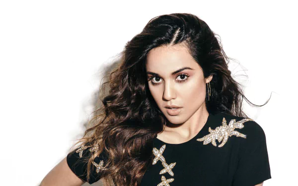 Portrait of American actress Summer Bishil with long brunette hair and brown eyes, set against a white background in 4K Ultra HD quality.