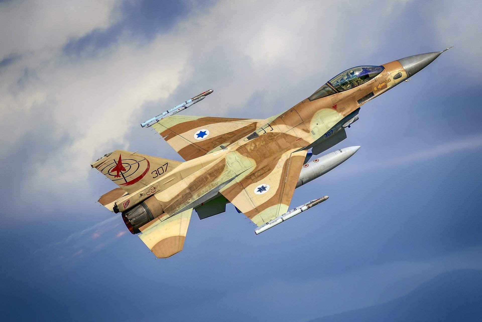 HD desktop wallpaper featuring a General Dynamics F-16 Fighting Falcon jet fighter warplane in military camouflage flying against a blue sky.