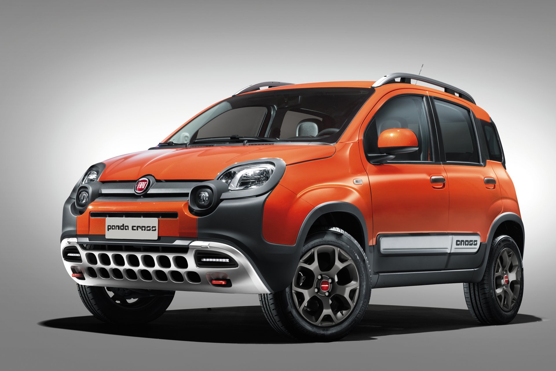 HD wallpaper featuring an orange Fiat Panda Cross SUV, showcasing its rugged design and compact vehicle style against a neutral background.