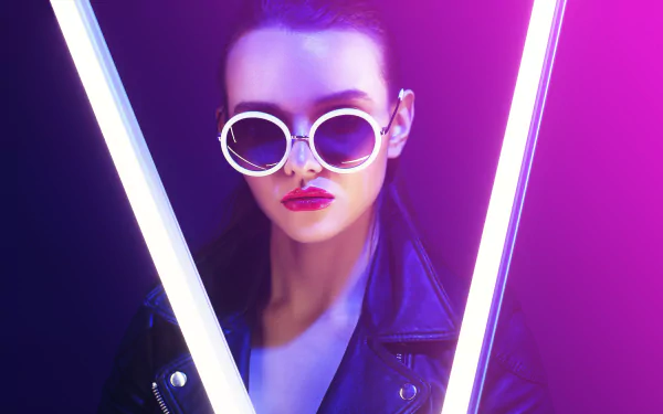 Model woman in a leather jacket and round sunglasses, bold lipstick, framed by neon V-shaped lights — 5K Ultra HD PC desktop wallpaper and background.
