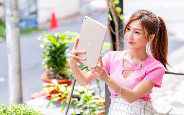 tablet ponytail brunette lipstick smile depth of field model woman asian HD Desktop Wallpaper | Background Image