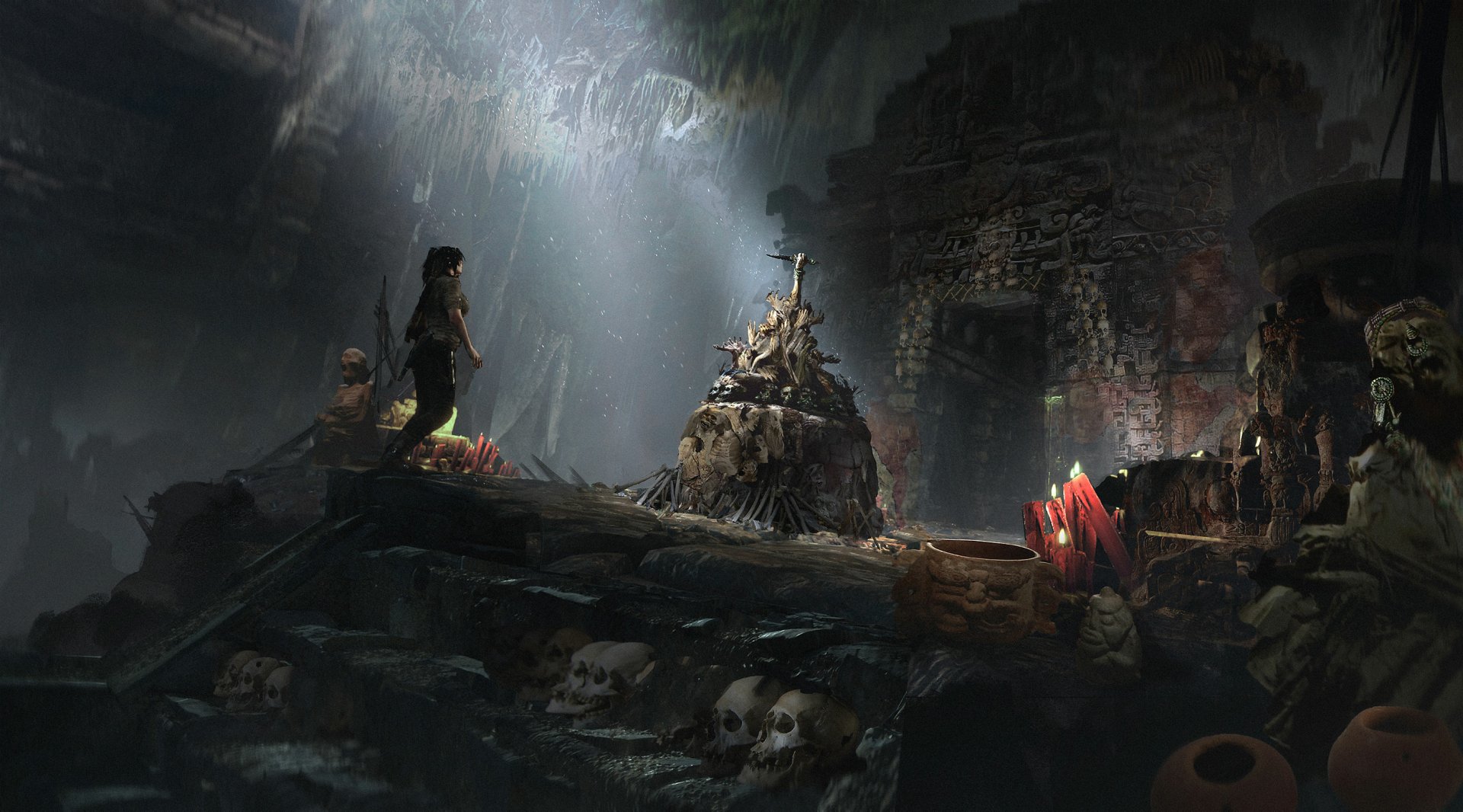 Lara Croft explores a dark, ancient cave filled with skulls and glowing crystals in this HD PC Desktop Wallpaper from the video game Shadow of the Tomb Raider.