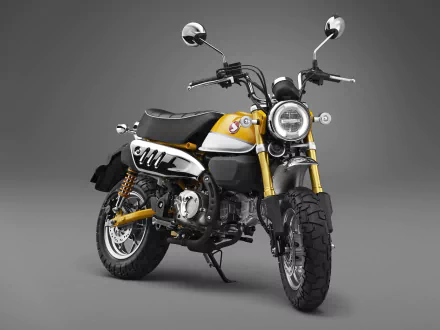 4K Ultra HD wallpaper of a yellow and black Honda Monkey motorcycle against a gray background, highlighting its compact and stylish design.