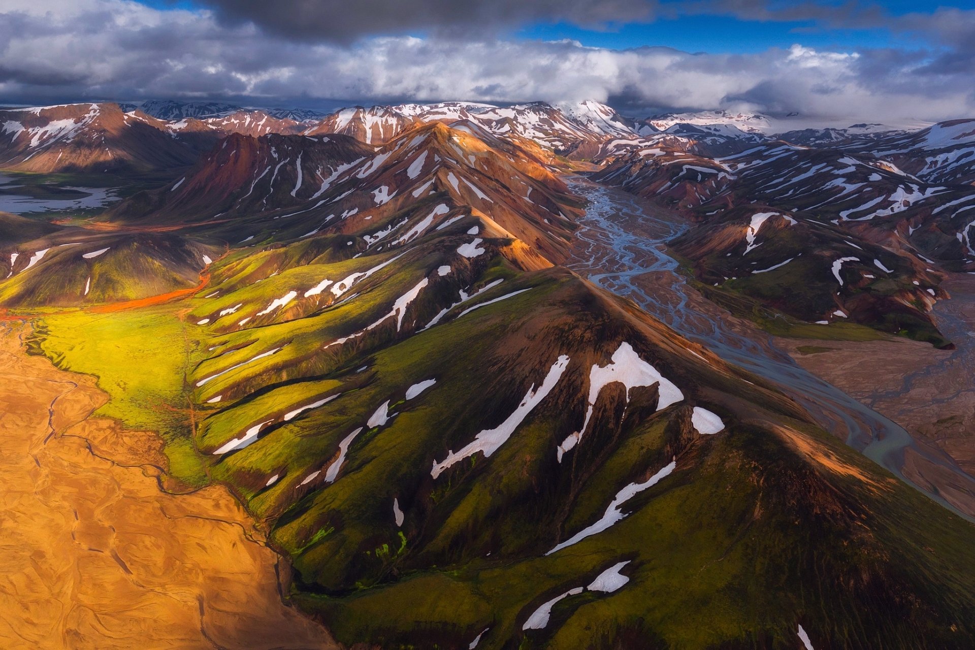 A stunning HD desktop wallpaper featuring a breathtaking landscape with mountains, valleys, and clouds creating a serene natural scene.