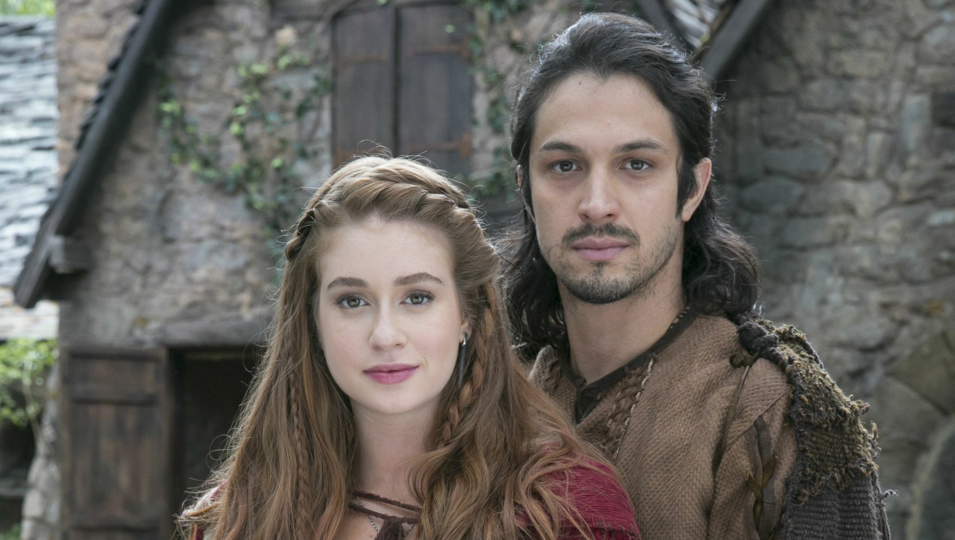 A captivating HD wallpaper featuring characters from the TV show Deus Salve o Rei, set against a rustic background, highlighting their timeless bond and regal aura.