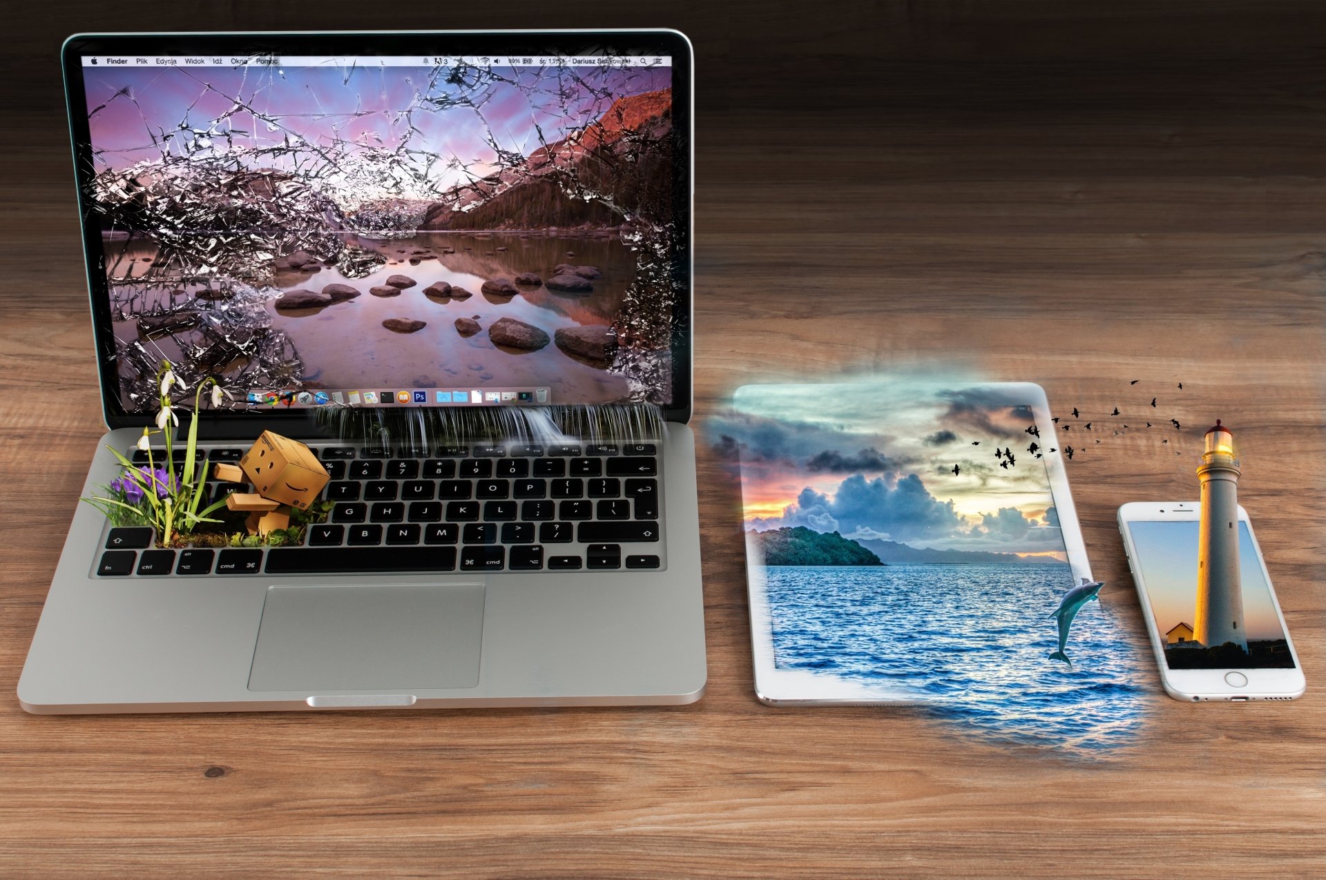 4K Ultra HD PC desktop wallpaper and background: surreal photo-manipulation of a laptop, tablet and phone with a lighthouse and ocean scene spilling out, a small Danbo toy on the keyboard.