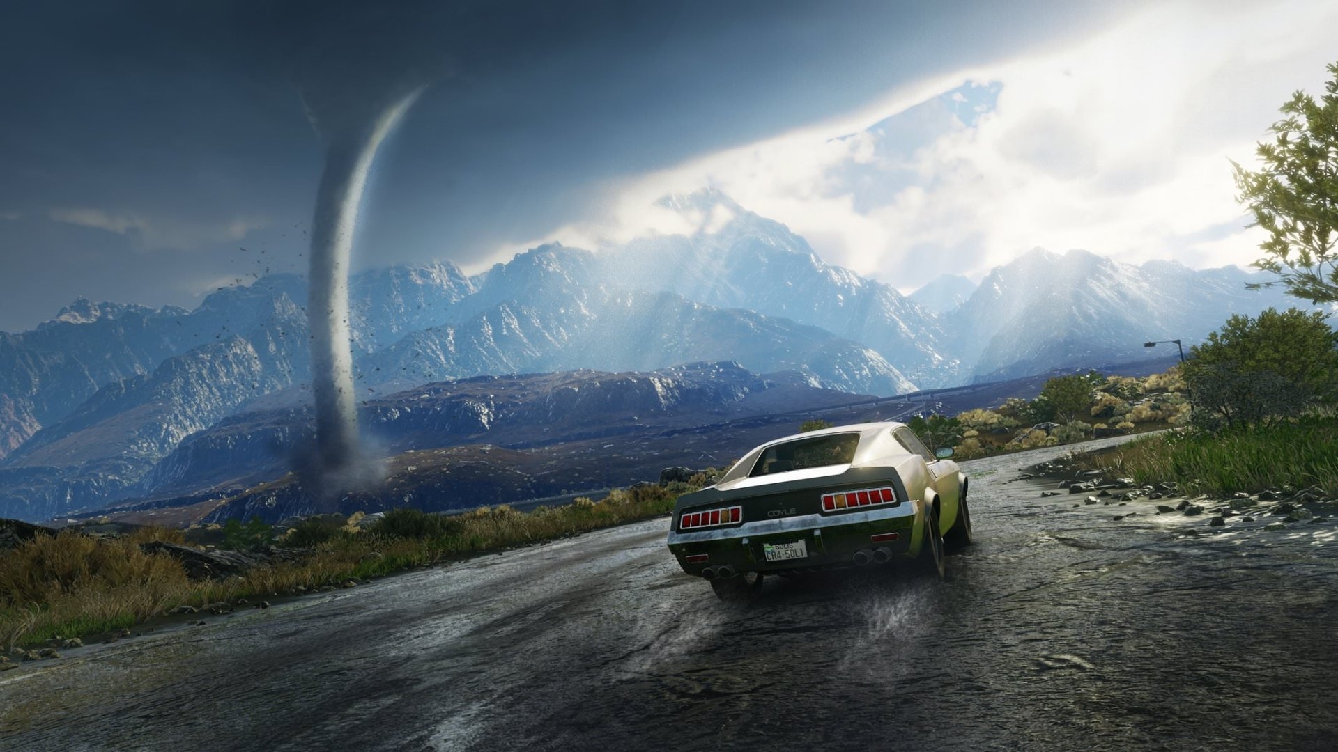 HD wallpaper of Just Cause 4 video game, featuring a car driving on a wet road towards mountains, with a tornado spiraling in the background.