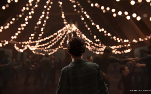 HD wallpaper from The Last of Us Part II featuring Ellie in the foreground, gazing at a warmly lit dance hall adorned with string lights, capturing an atmospheric moment from the video game.