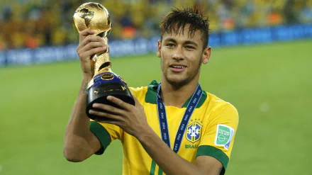 Neymar, Brazilian soccer star, holding a trophy on the field, captured in a vibrant 4K Ultra HD desktop wallpaper.