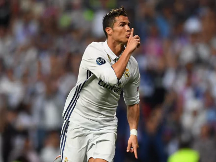 Cristiano Ronaldo celebrates on the soccer field, wearing a Real Madrid jersey, in this high-definition desktop wallpaper and background.