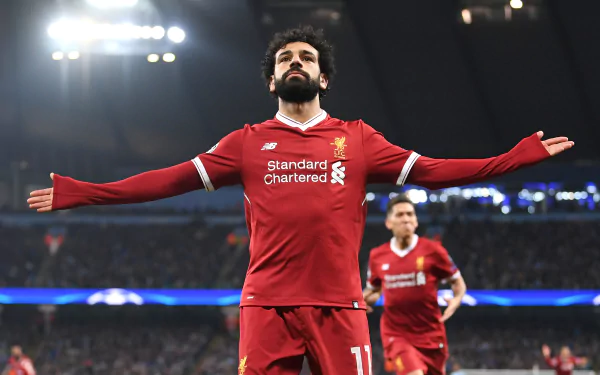 HD desktop wallpaper featuring Egyptian soccer star Mohamed Salah in a celebratory pose during a match, highlighting his impact in sports.