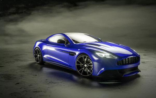 Blue Aston Martin Vanquish grand tourer supercar on reflective wet pavement, high-detail 4K Ultra HD PC desktop wallpaper background.