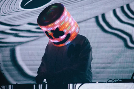 HD desktop wallpaper featuring DJ Marshmello, with his iconic illuminated helmet, performing music against a dynamic background.