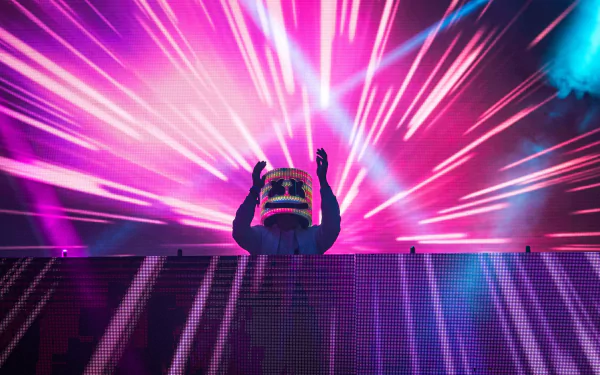 HD desktop wallpaper of DJ Marshmello performing, with vibrant pink and blue lights in the background, creating a dynamic music-themed visual.