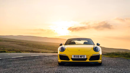 Front view of a yellow Porsche 911 Carrera T at sunset on a country road — 4K Ultra HD desktop wallpaper of a Porsche 911 sports car.